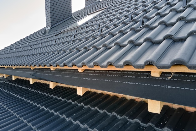 closeup-house-roof-top-covered-with-ceramic-shingles-tiled-covering-building-construction_127089-31831