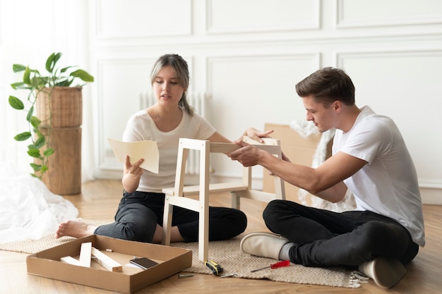 couple-assembling-diy-chair-from-scratch_53876-132351