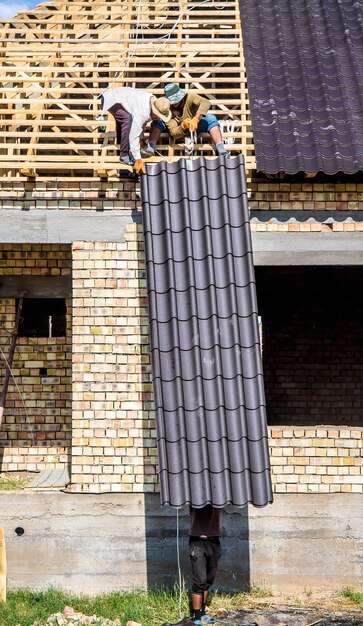 man-carries-metal-profile-construction-site_811250-7706