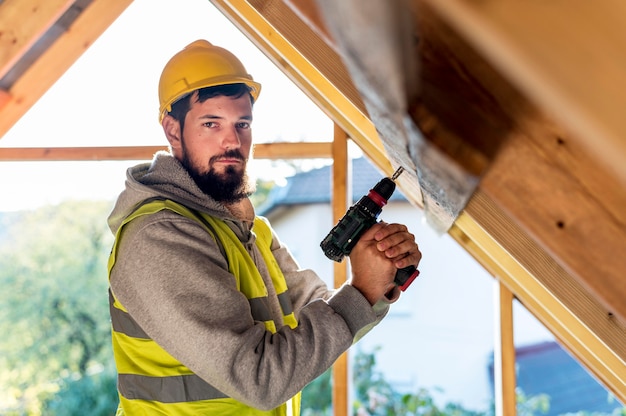 man-holding-hammer-drill-looking-away_23-2148748783
