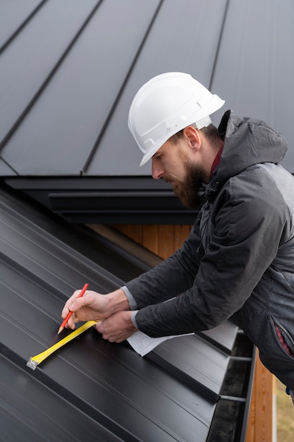 man-working-roof-medium-shot_23-2149343644