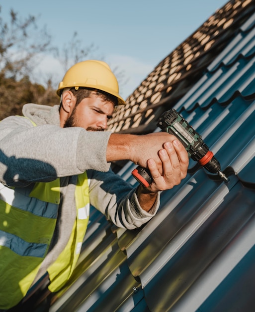 side-view-man-working-roof-with-drill_23-2148748775
